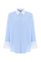 Blue French shirt by Acaria Studio featuring a classic fit, styled with a collar and button front, displayed on a hanger.