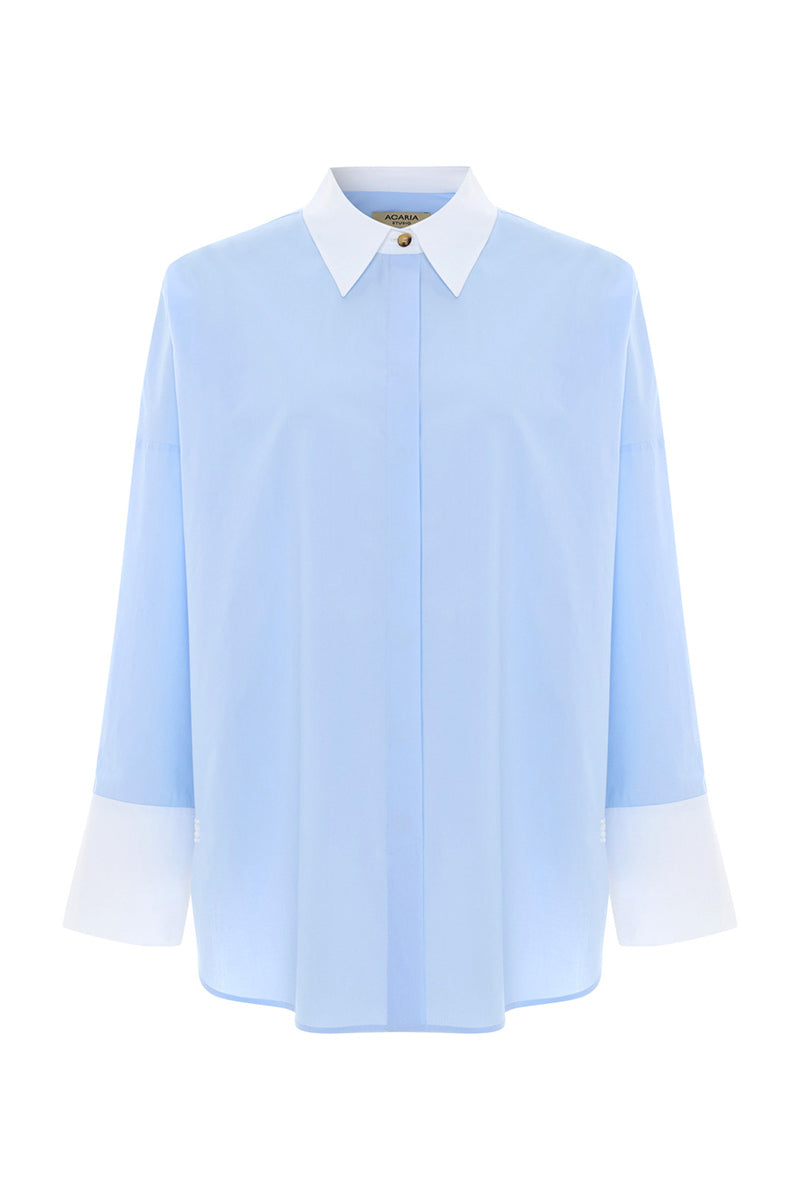 Blue French shirt by Acaria Studio featuring a classic fit, styled with a collar and button front, displayed on a hanger.