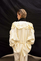 Vaska beige oversized jacket with rose embroidery, featuring a relaxed fit and stylish floral details on the front.