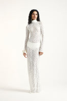 Off-white Deme By Gabriella amber maxi dress displayed on a model, featuring flowing fabric and elegant design.