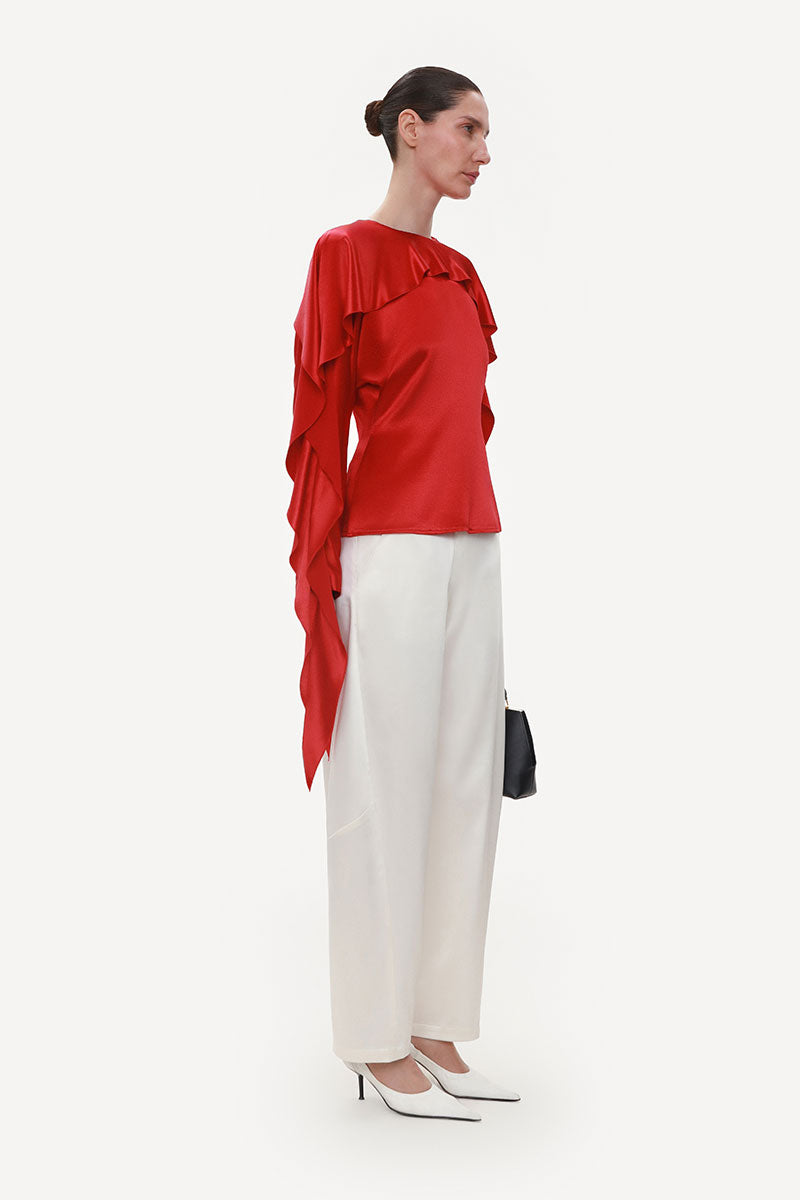 Ivory satin barrel-leg trousers by ELENAREVA featuring a sleek, tailored design and relaxed fit.