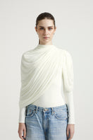 Deme By Gabriella Lisbeth top in off-white, casual sleeveless sleeveless blouse with a relaxed fit, displayed on a hanger.