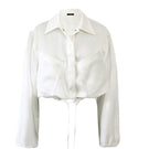 White Kris Marán silky bomber jacket with a smooth fabric finish, stylishly displayed on a hanger.