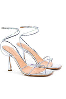 Silver crystal Kolane Kim sandal with transparent straps and open toe design, featuring elegant crystal embellishments.