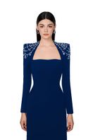 Navy blue long sleeve trapezoid neckline Tracy Studio bodycon gown displayed on a hanger with a fitted silhouette.