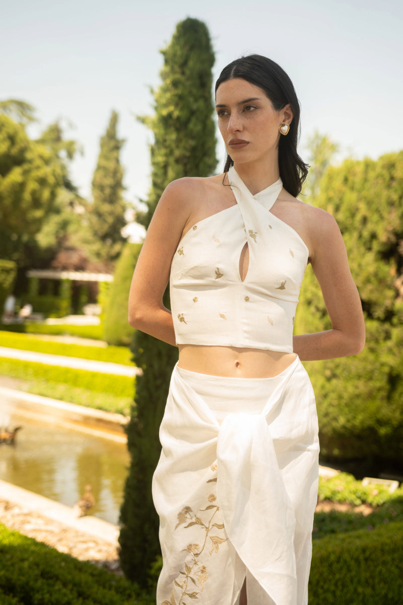 Estefania white gold lilies pareo halter top featuring floral design and halter neckline, made of lightweight fabric.