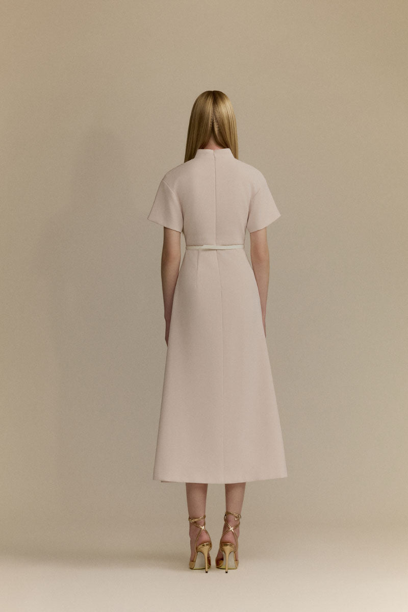 White Plan Rosalie Dress, midi dress with flowy fabric and feminine design, displayed on a hanger against a neutral background.