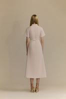 White Plan Rosalie Dress, midi dress with flowy fabric and feminine design, displayed on a hanger against a neutral background.