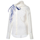 White asymmetric floral shirt by LECIA featuring a stylish, modern design with floral patterns and unique asymmetrical details.