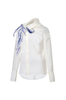White asymmetric floral shirt by LECIA featuring a stylish, modern design with floral patterns and unique asymmetrical details.
