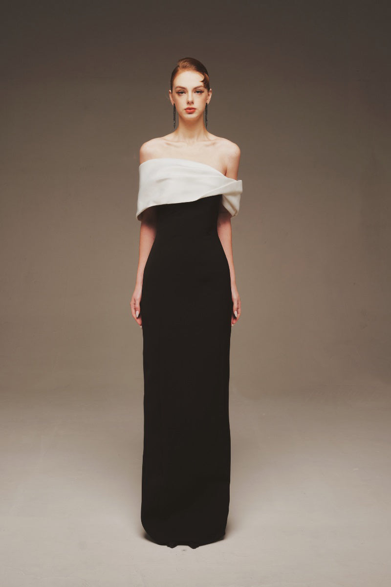 Elegant Margée Atelier Serene off-shoulder maxi gown with flowing fabric and subtle draping, perfect for formal occasions.