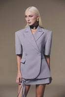 Keira Tong grey Lily mini skirt made of soft fabric, shown on a hanger, highlighting its slim fit and stylish design.