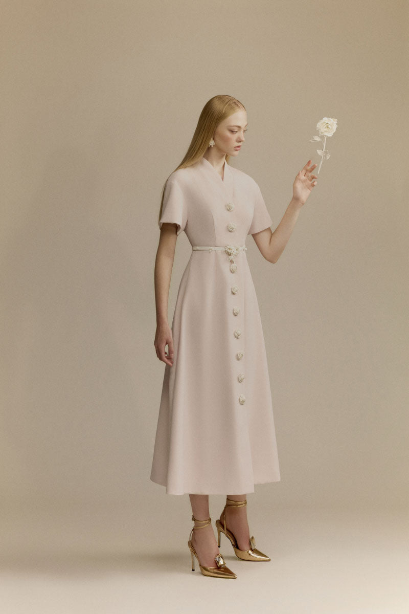 White Plan Rosalie Dress, elegant midi dress with a flowing silhouette and floral details, shown in a stylish fashion image.