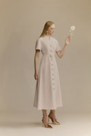 White Plan Rosalie Dress, elegant midi dress with a flowing silhouette and floral details, shown in a stylish fashion image.