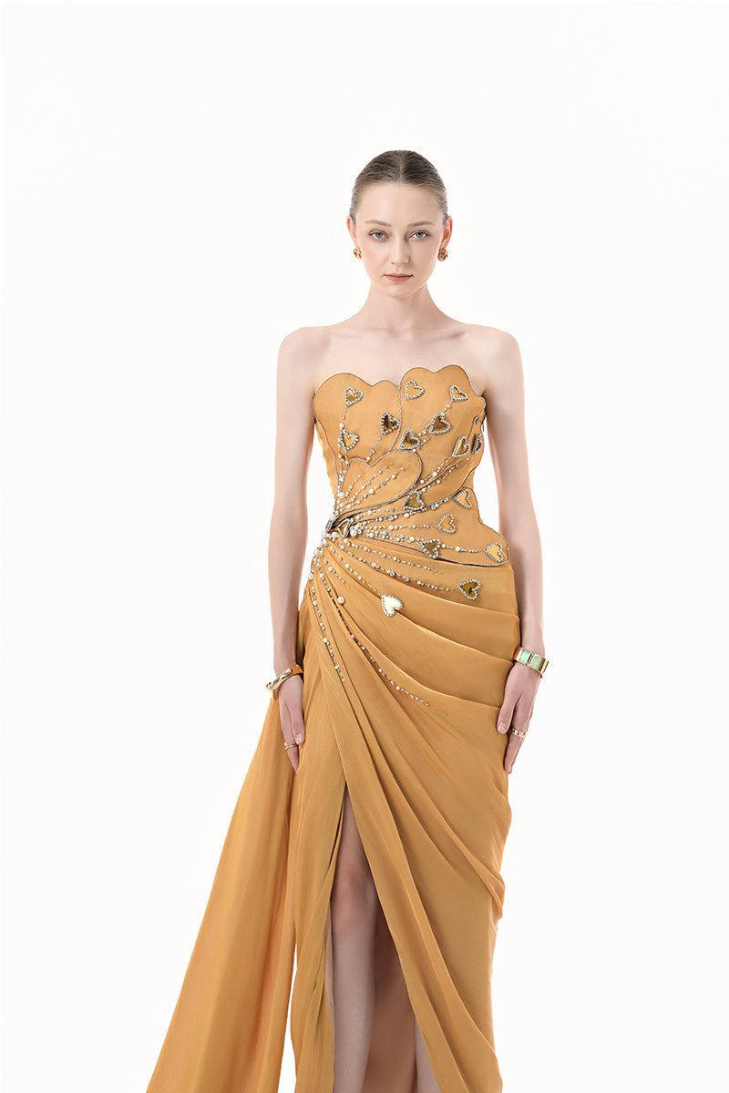 Elegant chartreuse gold gown by Happy Clothing featuring heart embellishments and draped design, showcased in a full-length image.
