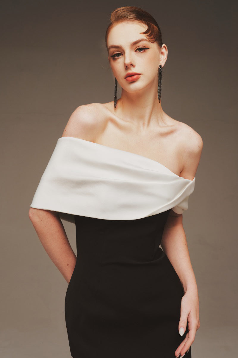 Elegant white off-shoulder maxi gown by Margée Atelier, flowing fabric with a fitted bodice and long skirt.