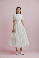 Elegant white tulle gown by White Plan, featuring a flowing design with delicate details, perfect for formal occasions.