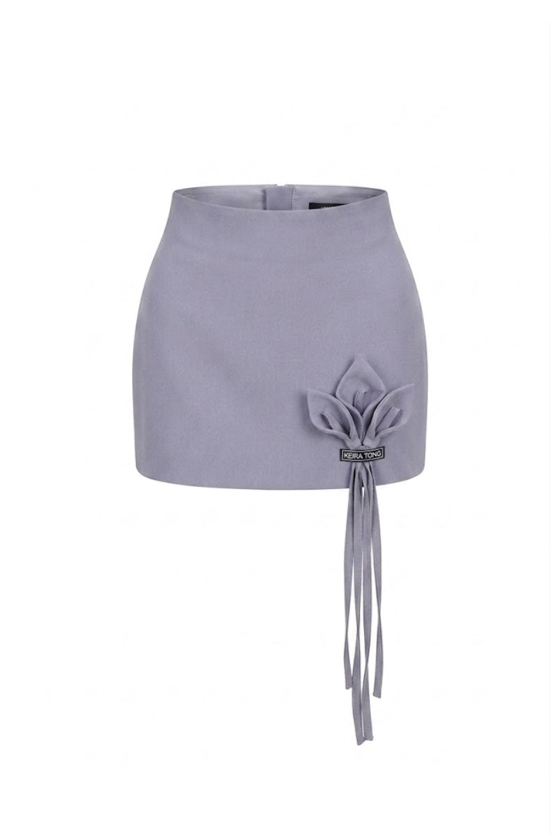 Keira Tong grey Lily mini skirt, stylish short skirt with a fitted waistband and smooth fabric, displayed on a hanger.