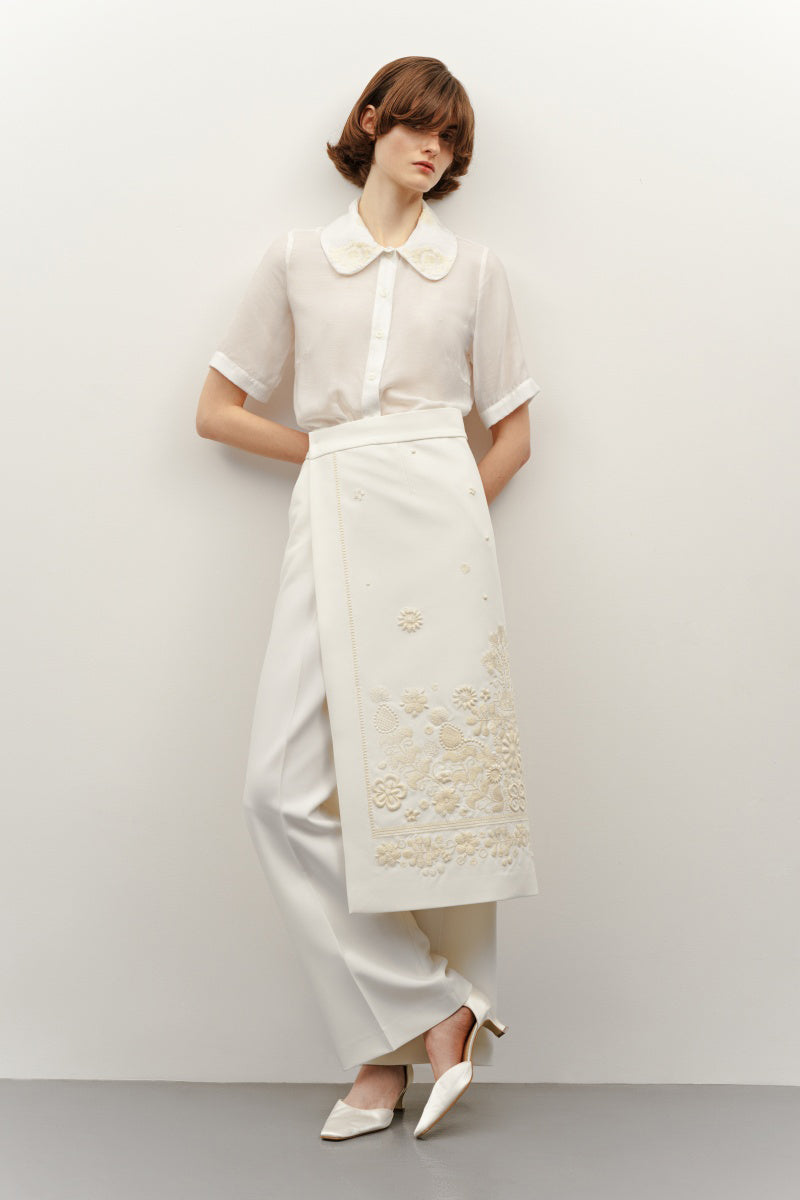 Elegant milk silk shirt with intricate ornament details from DELEGAN, featuring a soft, luxurious fabric and stylish design.
