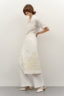 Cream-colored milk silk shirt with elegant ornament details from DELEGAN, featuring a classic collar and button-front design.