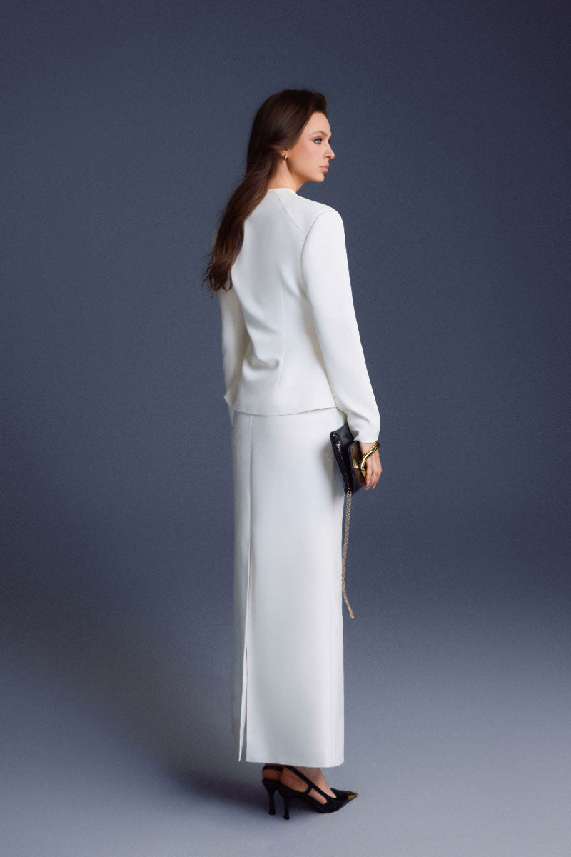 White folded button tops by Keira Tong, featuring a stylish design with buttons, perfect for casual or semi-formal wear.