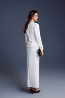 White waistband midi skirt by Keira Tong, featuring a flowy fabric and a cinched waist, displayed on a neutral background.