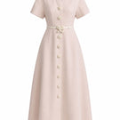 White Plan Rosalie Dress, a stylish midi dress with floral pattern, shown on a model in a bright, airy setting.