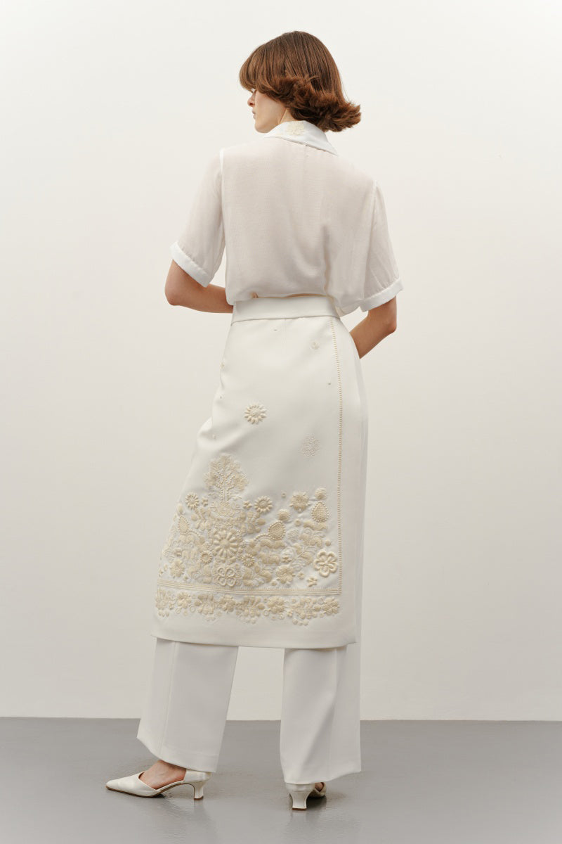 Elegant milk silk shirt with ornament details from DELEGAN, featuring a stylish design and intricate embellishments in soft fabric.
