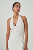 Summer Away Turin off-white maxi dress displayed on a hanger, showcasing its flowing fabric and elegant design.