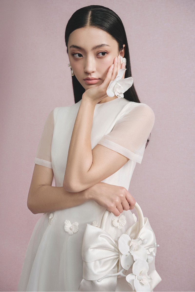White Plan Elina Tulle Dress, a midi dress with a flowing tulle fabric, styled for elegant occasions, shown in this image.