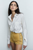 ZUT Saabel Mango shorts with a relaxed fit and vibrant orange color, displayed on a hanger against a neutral background.