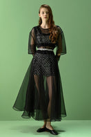 Lalo Thalia Top in black, stylish women's sleeveless blouse with a fitted design, showcased on a hanger.