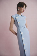 White Plan Serena belted midi dress displayed on a hanger with a focus on the dress's waist belt and flowy fabric.