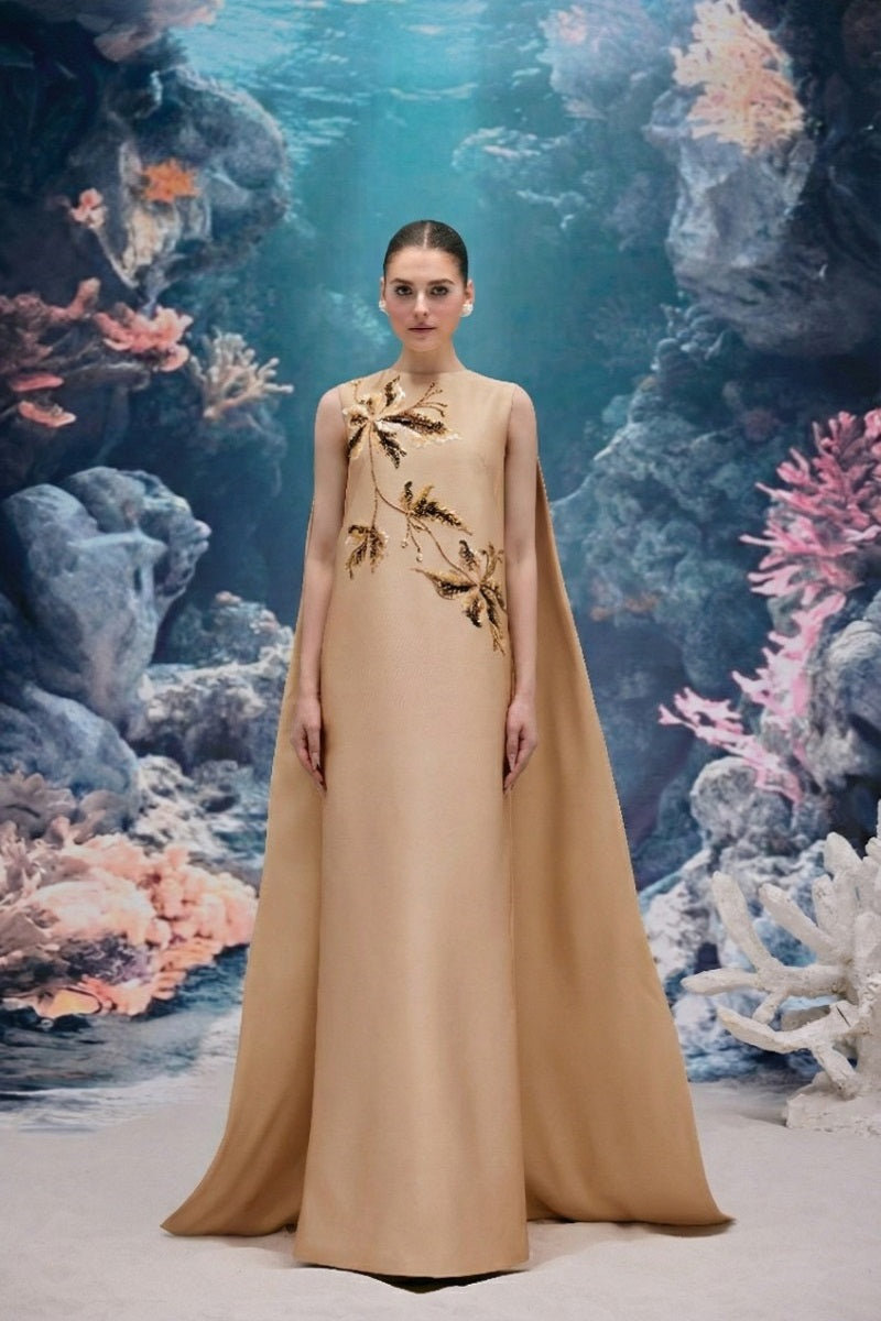 Beige LYSANDRA Royal Taffeta gown by 21Six, featuring elegant fabric and a flowing silhouette, shown on a model.