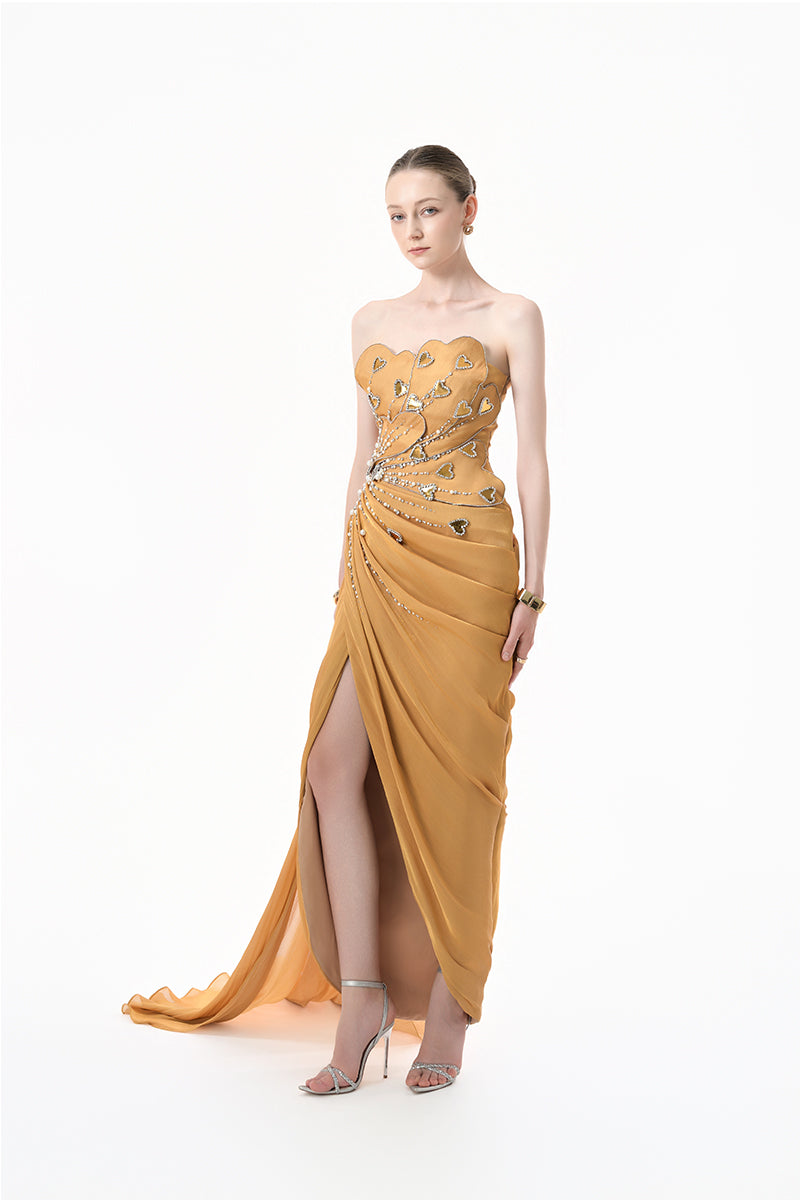Elegant chartreuse gold heart-embellished draped gown from Happy Clothing, featuring flowing fabric and intricate heart details.
