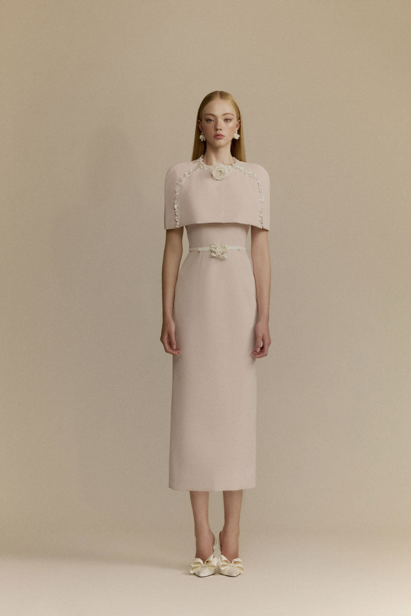 White Plan Mara pink midi dress displayed on a hanger, featuring a flowy fabric and stylish design perfect for casual or dressy occasions.