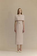 White Plan Mara pink midi dress displayed on a hanger, featuring a flowy fabric and stylish design perfect for casual or dressy occasions.