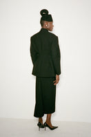 Nué Harlow black midi skirt displayed on a model, featuring a sleek, versatile design perfect for stylish everyday wear.