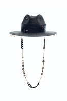 Black fedora hat by LE SH KA featuring shells and 24k gold-plated accessories, stylish headwear with decorative embellishments.