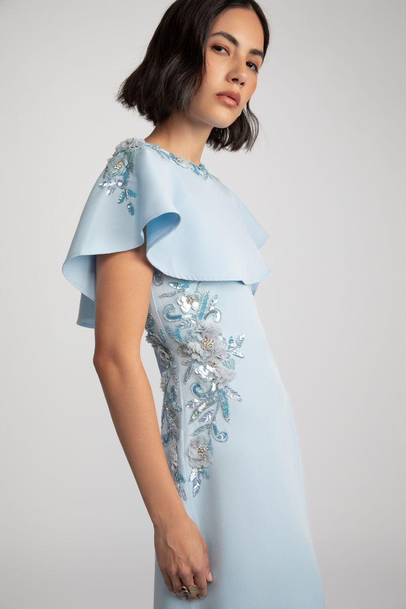 Elegant jade gown by Raishma featuring flowing fabric and intricate details, perfect for formal occasions.