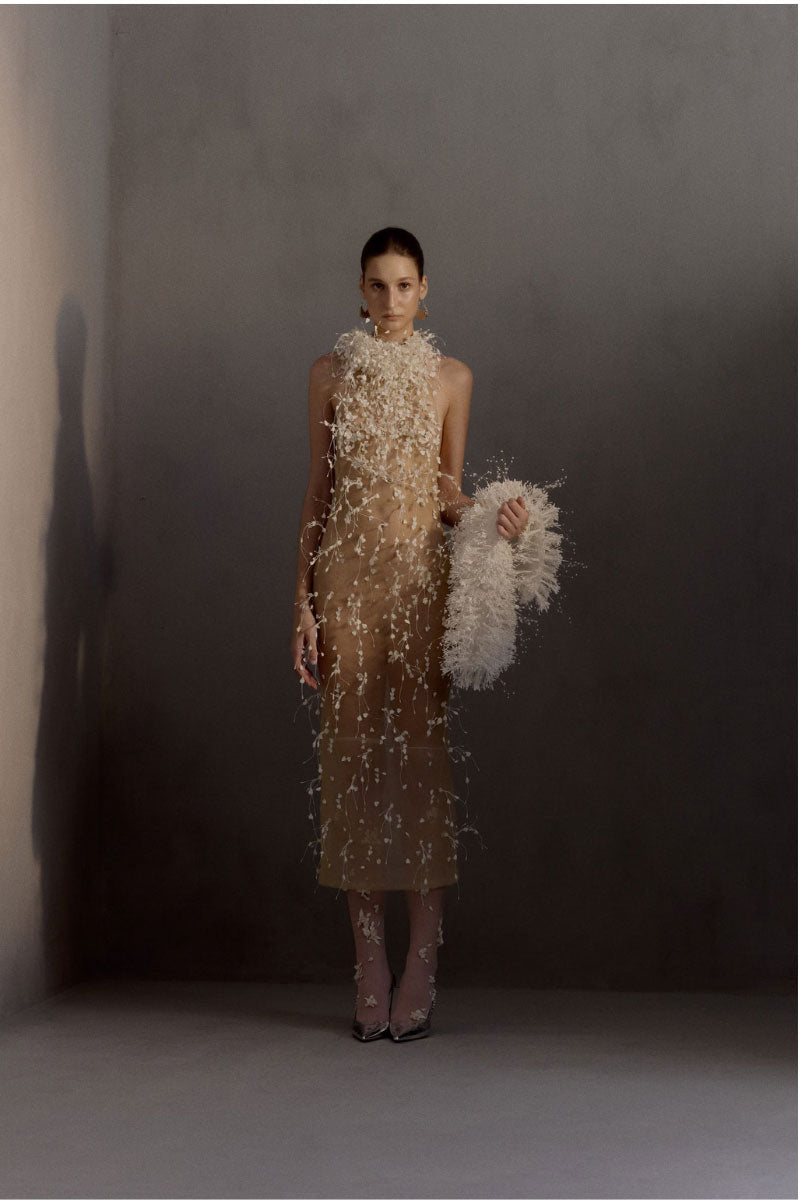White Plan Maliston gown featuring a flowing design with elegant fabric and intricate detailing, perfect for formal occasions.