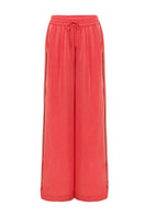 niLuu AQUAFLORA lounge pants in coral, lightweight and comfortable pants with a relaxed fit, shown on a model.