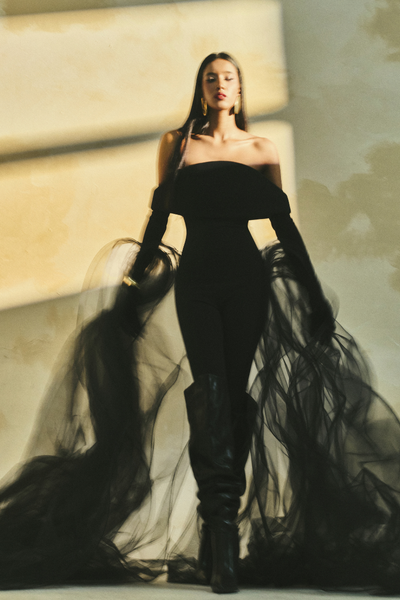 L'SCARLETT form-fitting off-shoulder long-sleeve poly crepe jumpsuit displayed on a model.