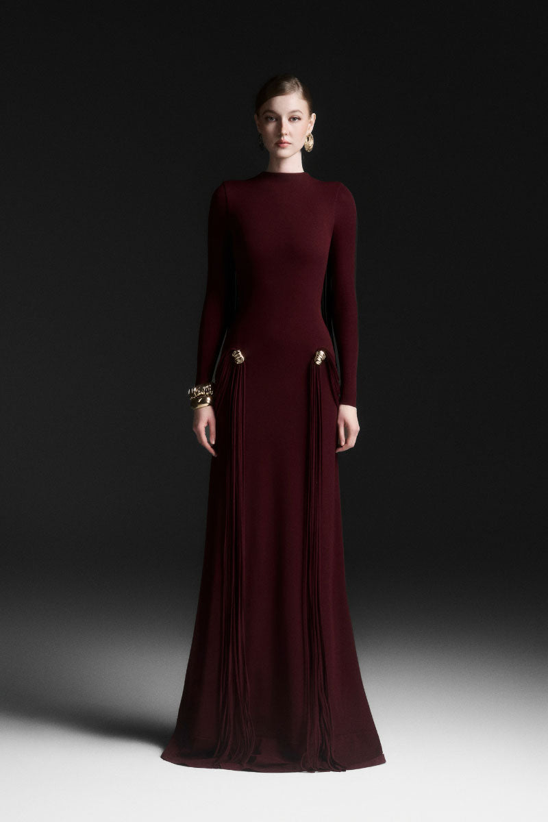 Red Avielle draped floor-length gown by Maison Des Copains, flowing fabric and elegant design showcased in this image.