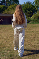 Unisex brown print twill pajamas set by Not Just Pajama, featuring long sleeves and matching pants for comfortable sleepwear.