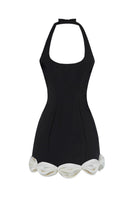 Black CAKE BOW mini dress by Stolen Stores, showing a fitted sleeveless design with a stylish bow detail at the waist.