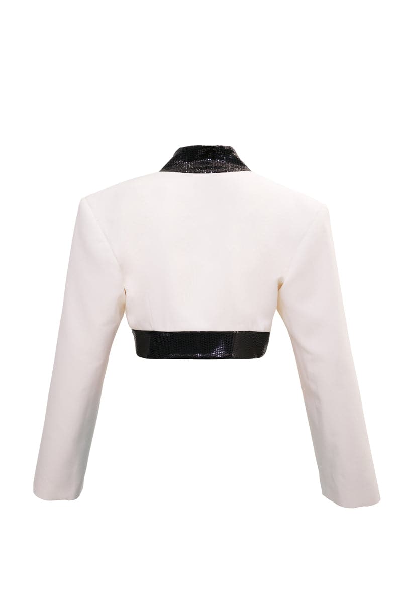 Blikvanger Milky bolero cardigan with black sequin details, lightweight knit and elegant design, worn over a stylish outfit.