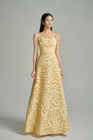 Beige CULT MIA X HAPPY CLOTHING flower wave A-line gown with flowing fabric and floral details, perfect for elegant occasions.