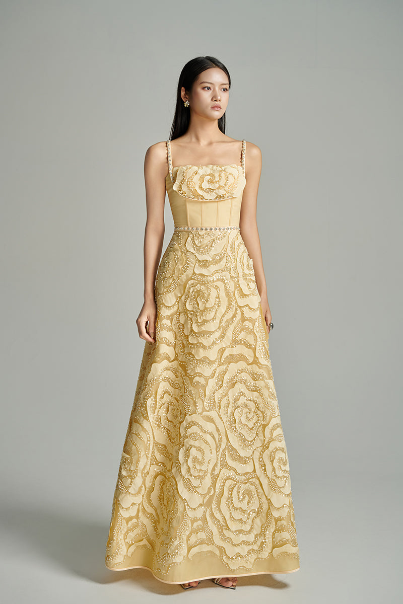 Beige CULT MIA X HAPPY CLOTHING flower wave A-line gown with flowing fabric and floral details, perfect for elegant occasions.