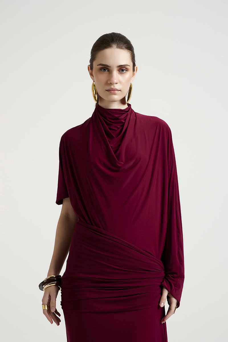 Deme By Gabriella Lorraine maxi dress in aubergine with flowing fabric and elegant design, displayed on a hanger.